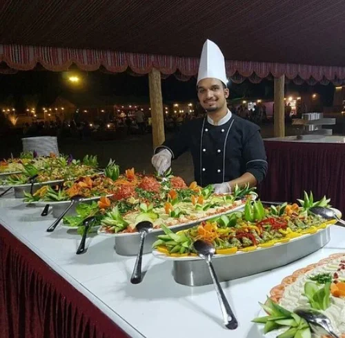 Traditional BBQ buffet dinner setup in Dubai desert safari with Arabic and international dishes